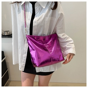 Close-up of metallic purple tote bag with stylish braided chain strap and glossy finish