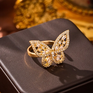 Macro shot of gold butterfly ring featuring intricate pavé-set white zircon stones