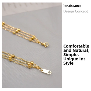 Detailed macro view of triple-layered gold titanium steel chain with small bead accents