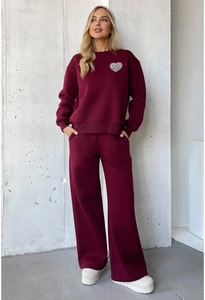 Detail of burgundy lounge set featuring heart print sweatshirt and wide-leg joggers