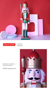 Close-up of hand-painted wooden nutcracker king with glitter sequins and gold scepter
