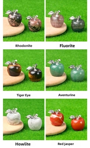 Macro shot of assorted natural crystal apple pendants with silver leaf detail