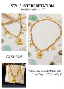 Detail of gold-plated ocean theme necklace with conch and pearl charms on cuban chain
