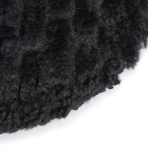 Close-up macro detail showing thick curly black faux fur texture of the winter bucket hat