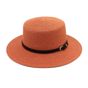 Detailed weave of a wide-brim boater hat with a black leather band and gold buckle