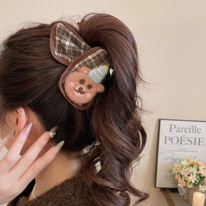 Close-up of a cute felt bear hair claw clip with brown plaid fabric for women hair styles