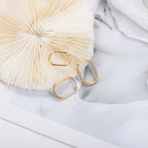 Minimalist gold oval hoop earrings in polished stainless steel for a modern geometric look