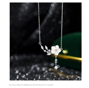 Macro shot of S925 silver peach blossom necklace with mother-of-pearl and shiny zircon