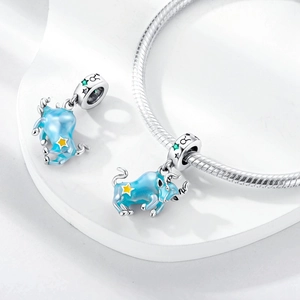 Detailed view of Taurus charm with blue enamel and yellow star on silver snake chain