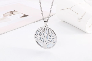 Macro detail of silver tree of life cutout pendant on a durable stainless steel chain