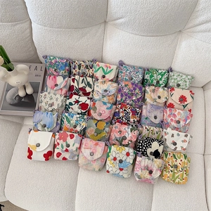 Detail of floral fabric mini pouches with vintage metal snap button and drawstring