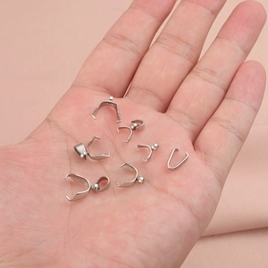 Polished stainless steel pinch bails for necklaces being held in hand to show size