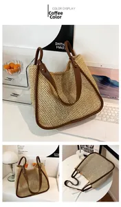 Detail view of woven straw tote bag with brown leather handles on a desktop