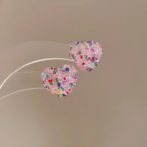 Detail of pink heart stud earrings with multi-color sparkling crystal inlay design