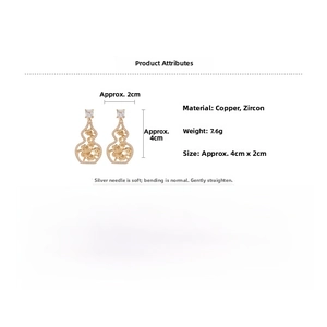 Detail view of gold gourd-shaped earrings with hollow carvings and inlaid cubic zirconia
