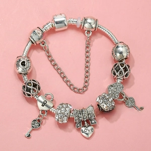 Detail of silver-plated snake chain bracelet with crystal charms and love heart pendant