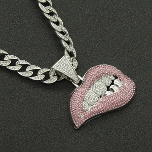 Close-up of hip hop cuban chain necklace with pink and white rhinestone lip pendant