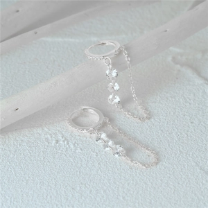 Close-up of 925 silver hoop earrings with chain tassel and three clear zircon stones