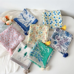 Collection of 7 patterned cotton linen scarves with tassels and floral motifs on white