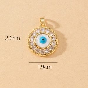 Macro view of evil eye pendant with cubic zirconia inlay measuring 2.6cm by 1.9cm