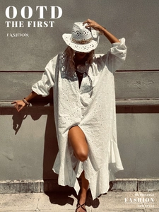 Detailed eyelet lace fabric of a white bohemian dress with elegant hollow embroidery