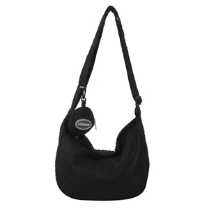 Minimalist black quilted hobo bag with adjustable strap and small coin pouch pendant