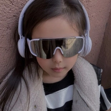 Kids sports cycling sunglasses with white frame and silver mirrored lens on a child model