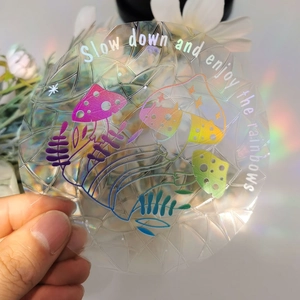 Rainbow suncatcher window cling with mushroom design showing colorful light effect