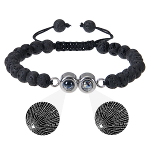Detail showing 100 languages I Love You projection stone on black lava rock bracelet