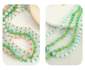 Close-up of multicolor cat eye stone beads with gold spacer beads on necklace