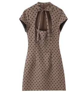Detail of retro brown polka dot mini dress with bow tie neckline and cutout front