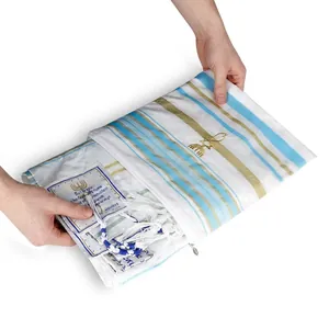 Detail of white polyester prayer tallit with blue stripes and golden Menorah embroidery