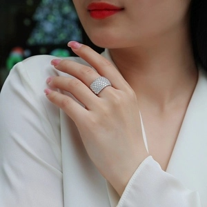 Sparkling S925 sterling silver band ring with pave-set moissanite stones on model's hand