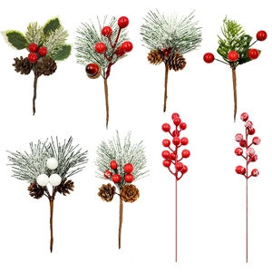 Detail of Christmas artificial berry picks with pine needles and snowy pine cones