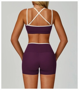 Close-up of cross-back sports bra and high-waist shorts in purple with white trim