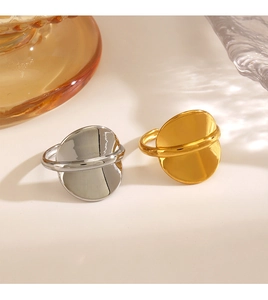 Detailed view of minimalist gold and silver polished circular rings on an aesthetic background