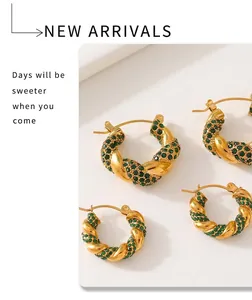 Macro shot of gold U-shaped twisted earrings with emerald green zircon paving detail