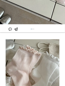 Detail of pink and white ruffled edge socks made of soft premium cotton fabric
