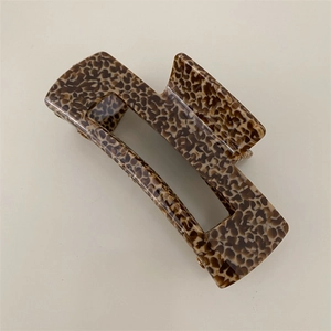 Detailed view of the leopard print tortoiseshell hair claw clip with a hollow square design