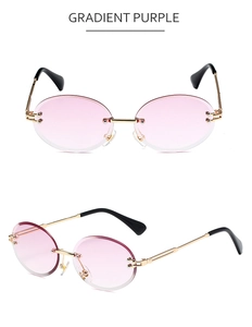 Close-up of rimless gradient purple lenses and gold metal temples on sunglasses