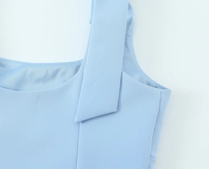 Detail shot of the light blue elastic tank top showing neck seam and shoulder strap