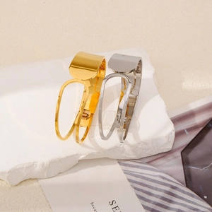 Minimalist high-polish gold and silver metal hair claws on stone decor base