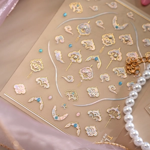 Elegant Chinese auspicious cloud nail art stickers with gold trim and iridescent pearl finish