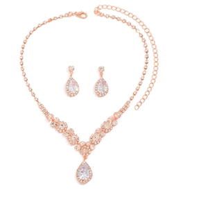 Macro detail of rose gold bridal jewelry set featuring pear-cut rhinestones and necklace