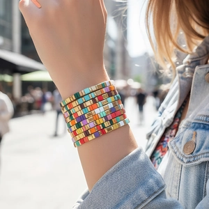 Bohemian colorful stackable tile bracelet set with gold alloy accents on a wrist