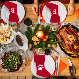 Red knit Christmas stocking cutlery holder with white letter and paw print patterns