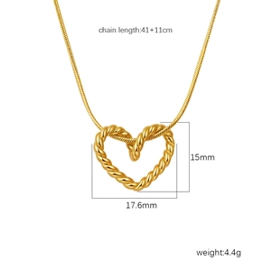 Close-up of golden heart pendant necklace with dimensions 15mm by 17.6mm on white backdrop