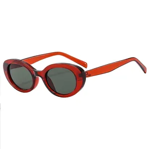 Fashionable red oval sunglasses with dark grey lenses and retro cat-eye design