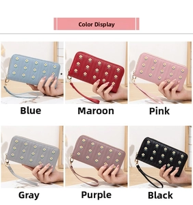 Close-up of long zip wallets in six colors with vertical quilting and daisy embroidery