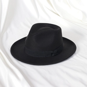 Macro shot of the black fedora felt hat featuring a classic grosgrain ribbon band and texture